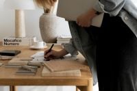 Kaboompics - Designer Writing on Architectural Concept Sheets among Material Samples