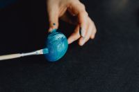 Kaboompics - Woman Painting Blue Easter Eggs