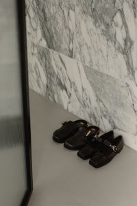 Kaboompics - Black and Brown Leather Shoes Against Marble Wall