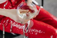 Kaboompics - White Turtleneck and Champagne Coupe over Red Sequin Trousers