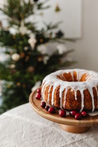 Kaboompics - Close Up of Iced Bundt Cake with Christmas Tree Bokeh