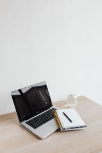 Kaboompics - Laptop, Notebook and Pen with Glass of Water on Desk