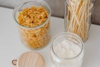 Kaboompics - Overhead Pantry Organization with Farfalle, Spaghetti and Flour in Glass Jars