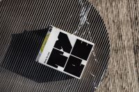 Kaboompics - Overhead Interior Flat Lay of a Design Book on a Striped Table and Textured Rug