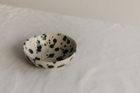 Kaboompics - Green Splatter Ceramic Bowl with Wide Neutral Copy Space