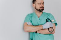 Kaboompics - Doctor Looking to the Side with Stethoscope and Crossed Arms, Wide Clinic Marketing Portrait