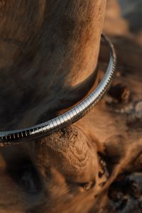 Kaboompics - Silver Chains and Crystal Necklace on Driftwood, Coastal Jewelry Close-Up