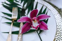 Kaboompics - Cymbidium Orchid Detail with White Plate and Silver Cutlery
