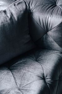 Close-ups of pillows and a grey sofa