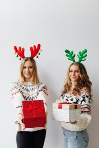 Kaboompics - Two Women in Reindeer Antlers Holding Christmas Presents