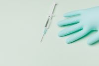 Kaboompics - Syringe and Nitrile Glove with Copy Space on Mint