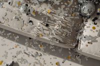 Kaboompics - Silver Confetti and Mirror Balls Scattered Across a Gray Couch