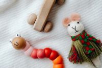 Kaboompics - Colorful Wooden Bead Caterpillar and Handmade Mouse Doll Close-Up
