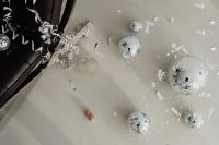 Kaboompics - Overhead View of Disco Balls and Confetti on White Floor Beside a Chair
