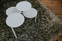 Kaboompics - White Nesting Side Tables on a Textured Rug at a Furniture Design Exhibition