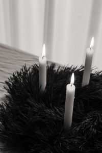 Kaboompics - Close Up Three Lit White Candles in Dark Evergreen Wreath