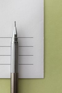 Kaboompics - Silver Mechanical Pencil on Textured Invitation Card Close Up