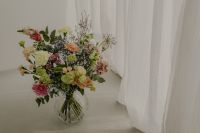 Kaboompics - Fresh Colorful Bouquet in Clear Vase by a Sheer Curtain