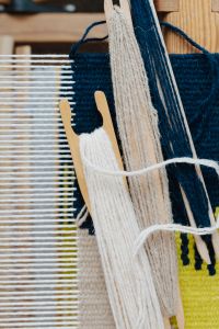 Kaboompics - Colorful Wool Yarn Beside Woven Loom Threads