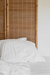 Kaboompics - White Bedding Against a Bamboo Headboard