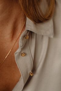 Kaboompics - Delicate Gold Pendant Necklace on Woman in Tan Silk Shirt
