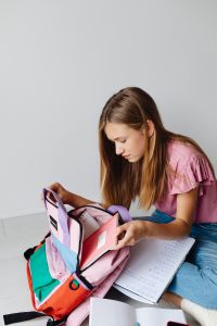 Kaboompics - Schoolgirl Preparing Backpack with School Supplies