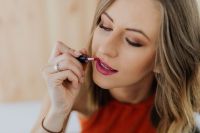 Kaboompics - Close-Up Beauty Portrait of a Woman Applying Lipstick in Soft Natural Light