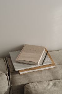 Kaboompics - Neutral Planner and Stacked Books on a Sofa, Minimal Home Office Styling