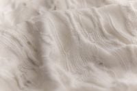 Kaboompics - Cream Knitted Fabric With Flowing Texture