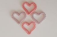 Kaboompics - Cluster of Four Pink and Pearl Beaded Hearts on Pale Beige Background