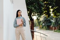 Kaboompics - Asian Woman Holding a Pink Laptop Outdoors