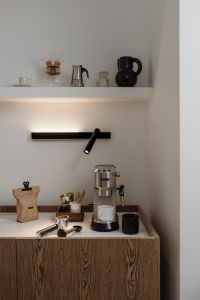Kaboompics - Cafecore Espresso Bar with Open Shelf and Black Wall Lamp