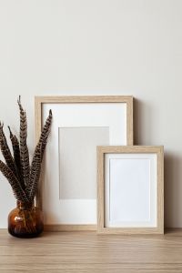 Empty Frame Mockup with Patterned Mug and Books for Wall Art Design