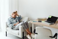 Kaboompics - Girl Doing Homework at Home with Laptop and Textbooks