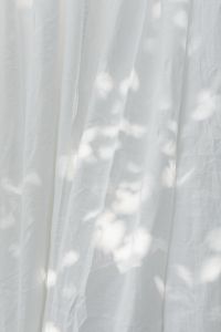 Kaboompics - Translucent White Curtain with Dappled Sunlight