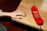 Kaboompics - Hand Resting Near Retro Red Telephone On Table