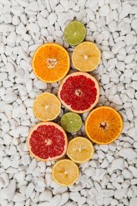 Kaboompics - Sliced Citrus Fruit on White Pebbles