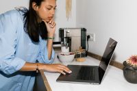 Kaboompics - Hard Flash Photography of Woman Working on Laptop Beside Espresso Machine