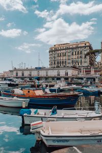 Kaboompics - Traditional Fishing Boats Crowded in Naples Marina Below Waterfront Hotel