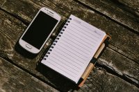 Kaboompics - Vintage Samsung Phone Beside a Lined Notebook