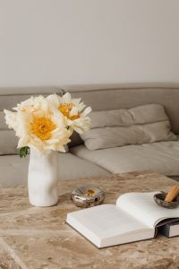 Kaboompics - White Flower Vase and Open Book in Neutral Living Room
