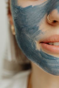 Kaboompics - Close Crop of Blue Clay Mask across Cheek with Gold Nose Ring