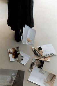 Kaboompics - Photographic Moodboard Prints Scattered on a Neutral Studio Floor