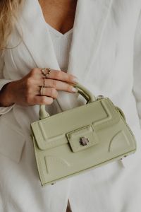 Kaboompics - Woman Holding Sage Structured Handbag by Handle, Gold Rings Detail