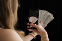 Kaboompics - Woman Photographing Cash for a Money Vision Board