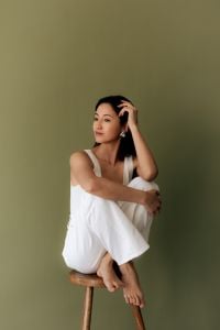 Kaboompics - Asian Woman Wearing Gold Earrings Sitting on Stool