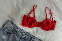 Kaboompics - Red Satin Bra and Blue Jeans Fashion Flat Lay