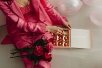 Kaboompics - Valentine’s Chocolates and Roses on Pink Satin Outfit