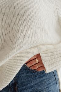 Kaboompics - Close-Up of Gold Rings on Jeans and White Sweater