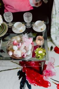 Kaboompics - Overhead Easter Coffee Table with Tea Cups, Glassware and a Pastel Egg Centerpiece